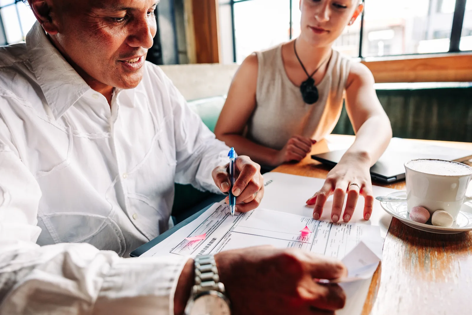 A client and adviser reviewing financial paperwork together