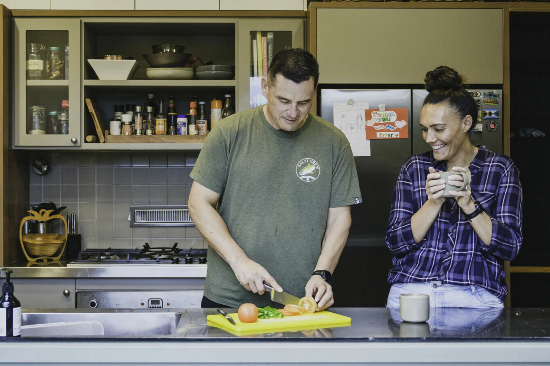 A business-owning couple preparing food together at home