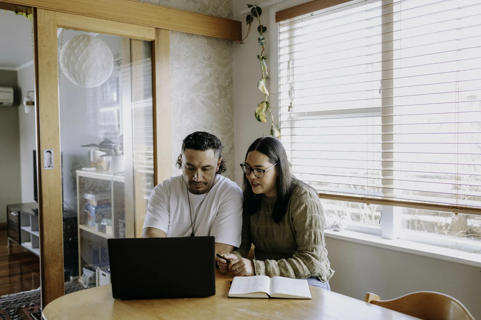 A couple reviewing their finances together at home
