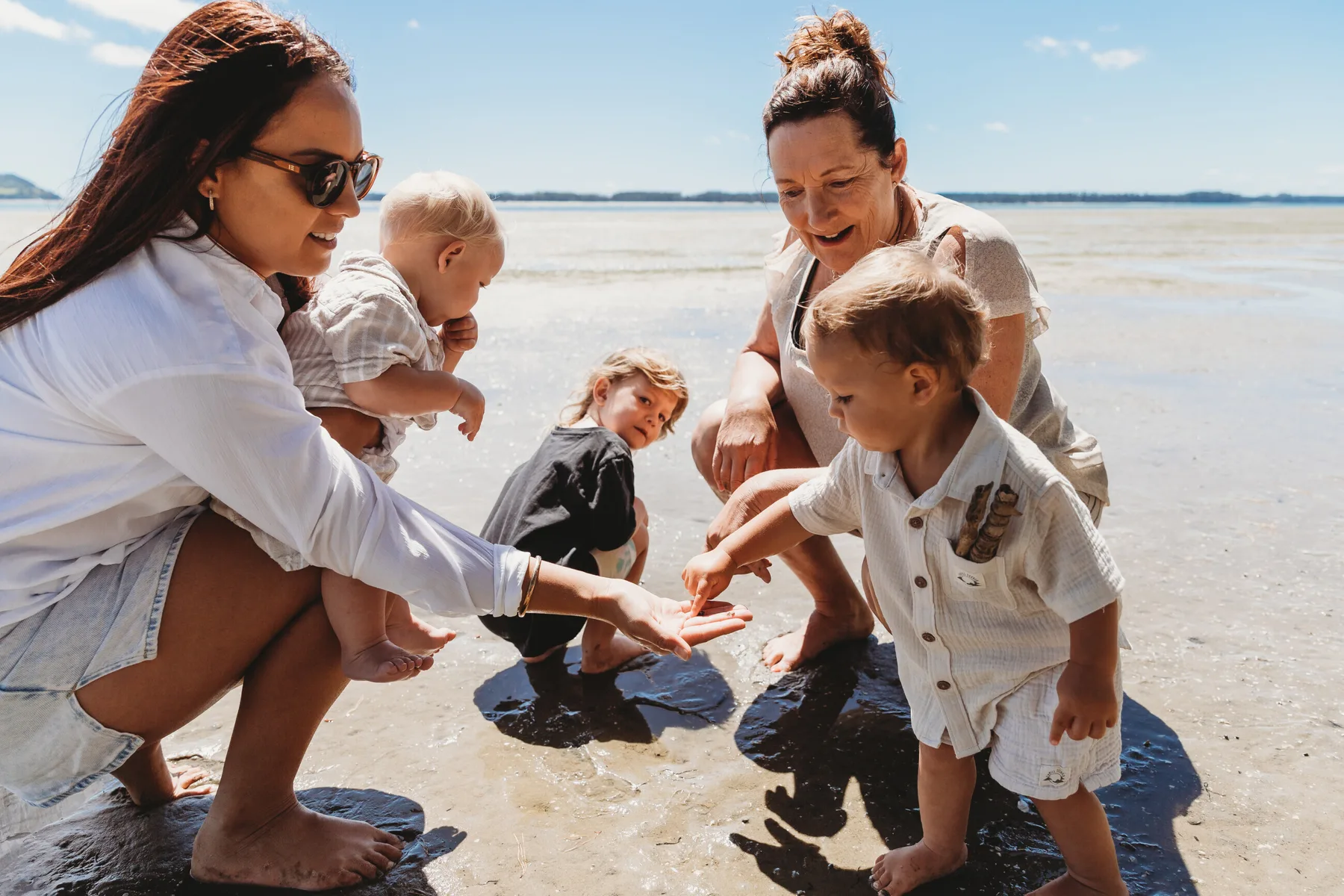 A family exploring the shoreline together