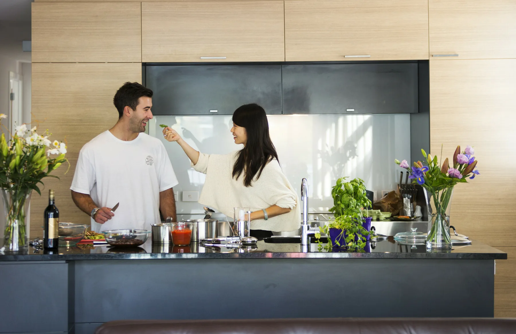 A couple preparing food together at home