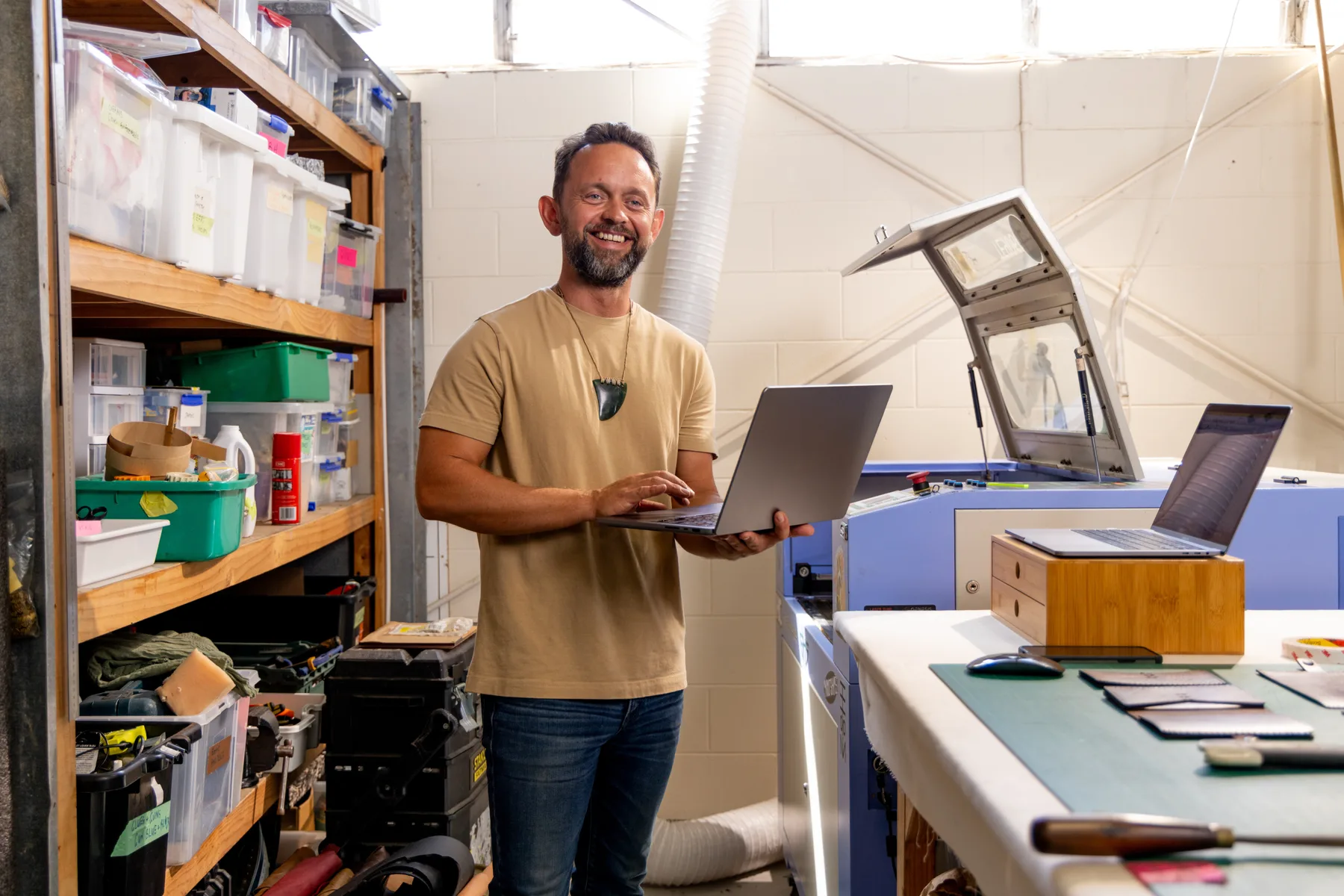 A business owner working with equipment in a workshop