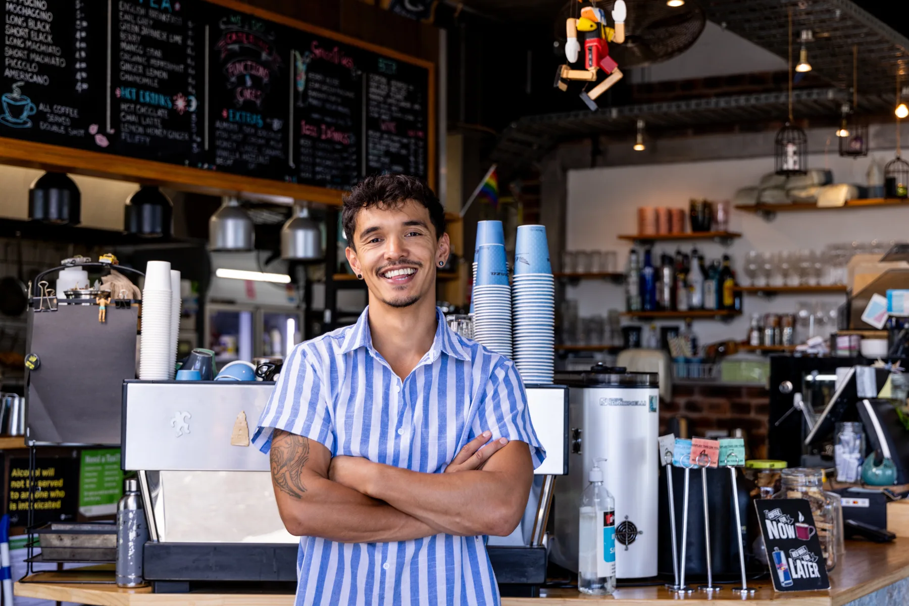 A café owner standing inside his business
