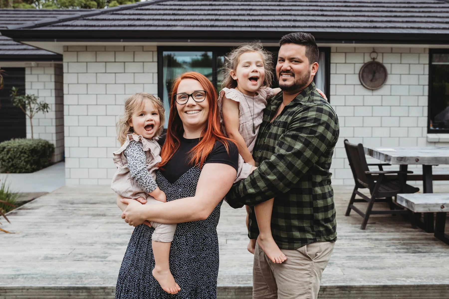 A family standing outside their home
